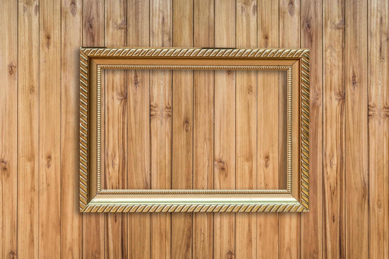 Golden frame picture on wood background photo