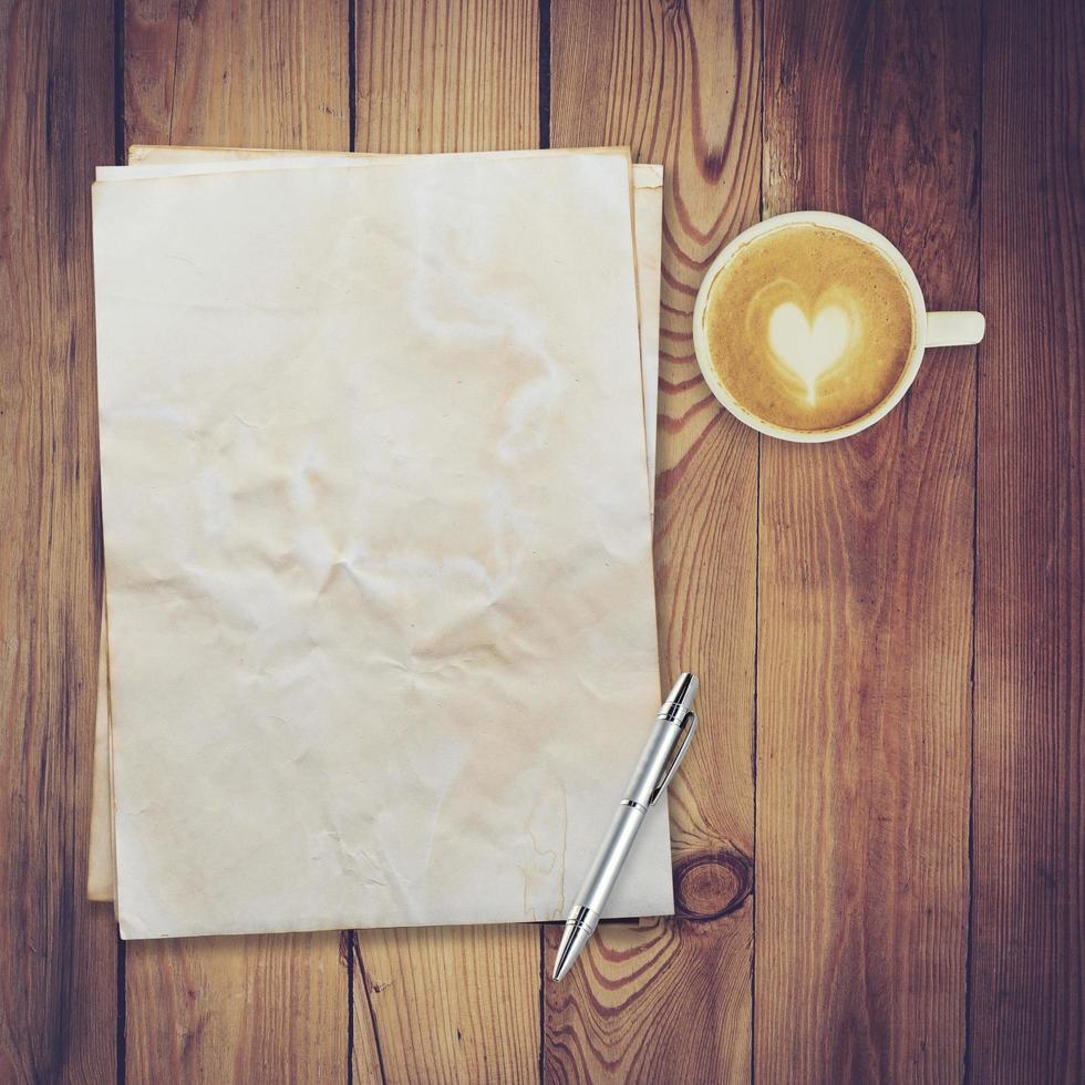 old paper and coffee on wood table texture with space for text photo
