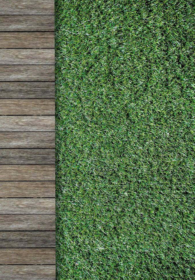 wood pathway and green grass in garden photo