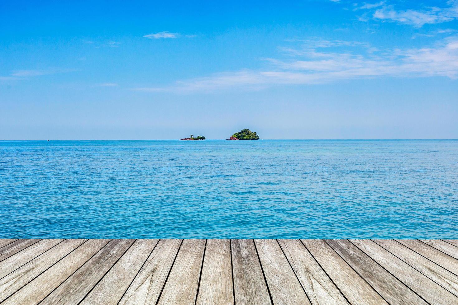 Under the blue sky, wood platform beside the sea. photo