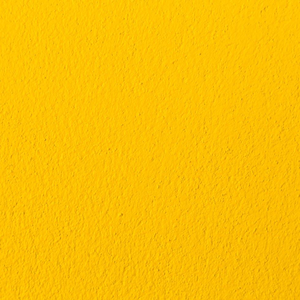 amarillo hormigón pared textura y antecedentes con espacio foto