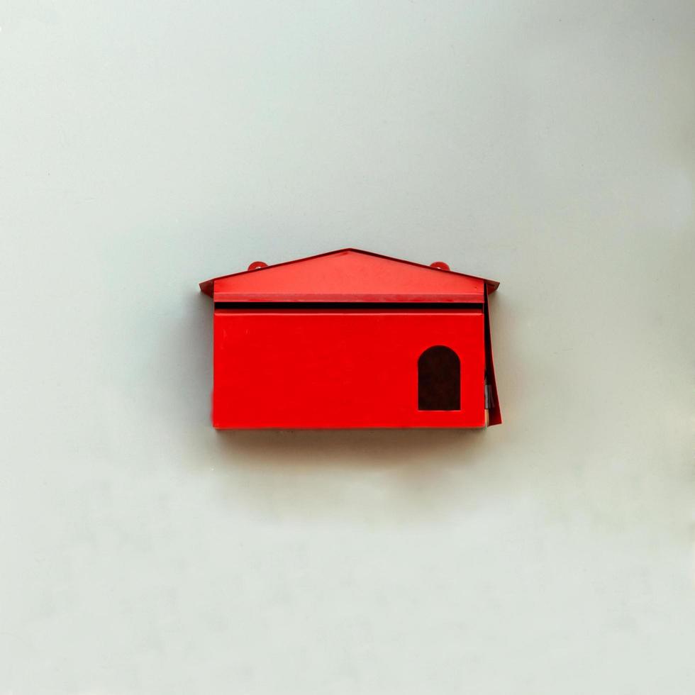 Red mailbox on wall home photo