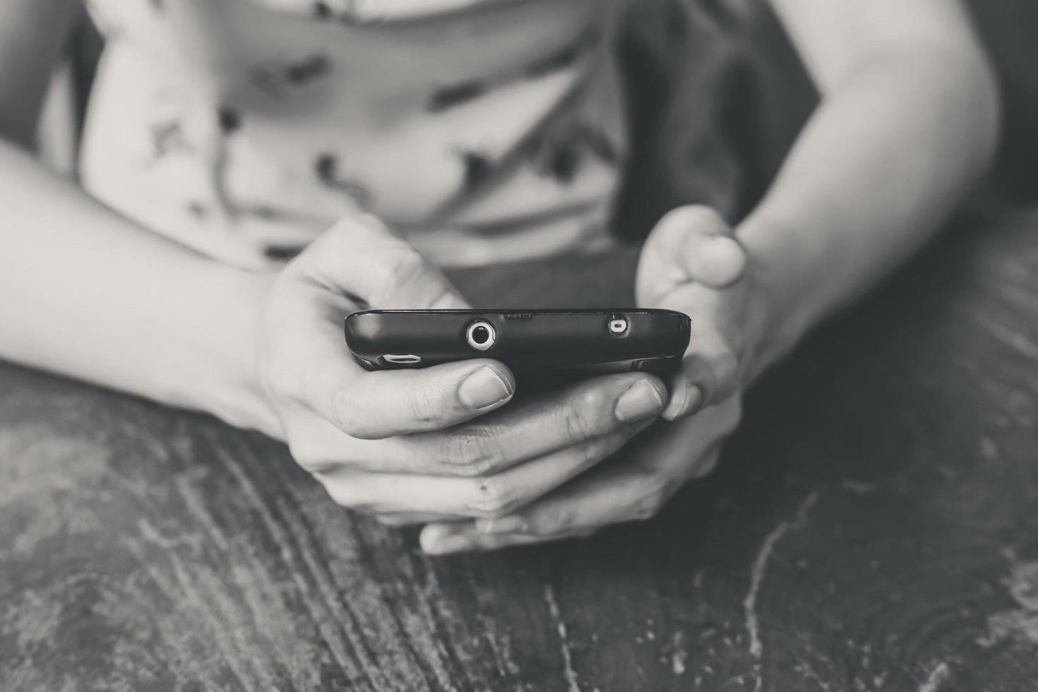 cell phone on hand woman black and white vintage with depth of field photo