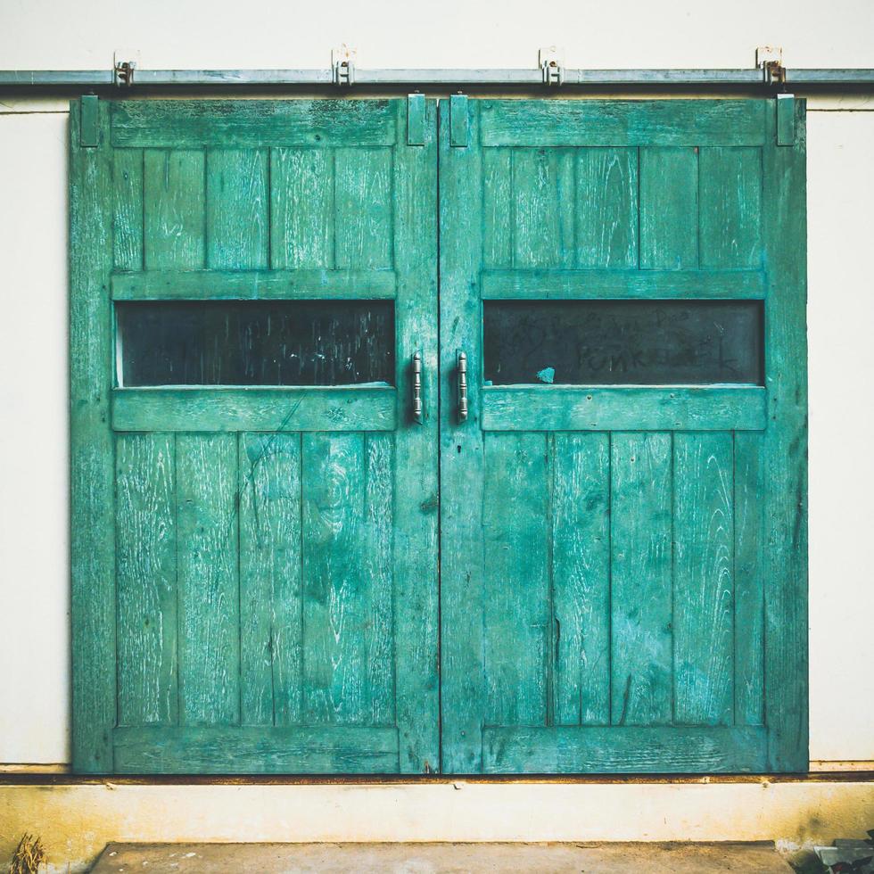 Vintage door on green cement wall photo