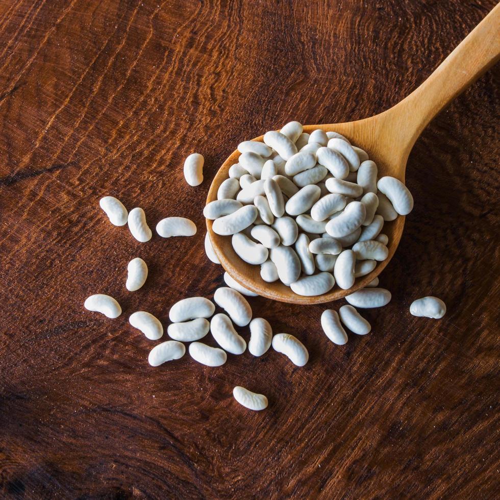 close up bean seed spoon on wood table photo