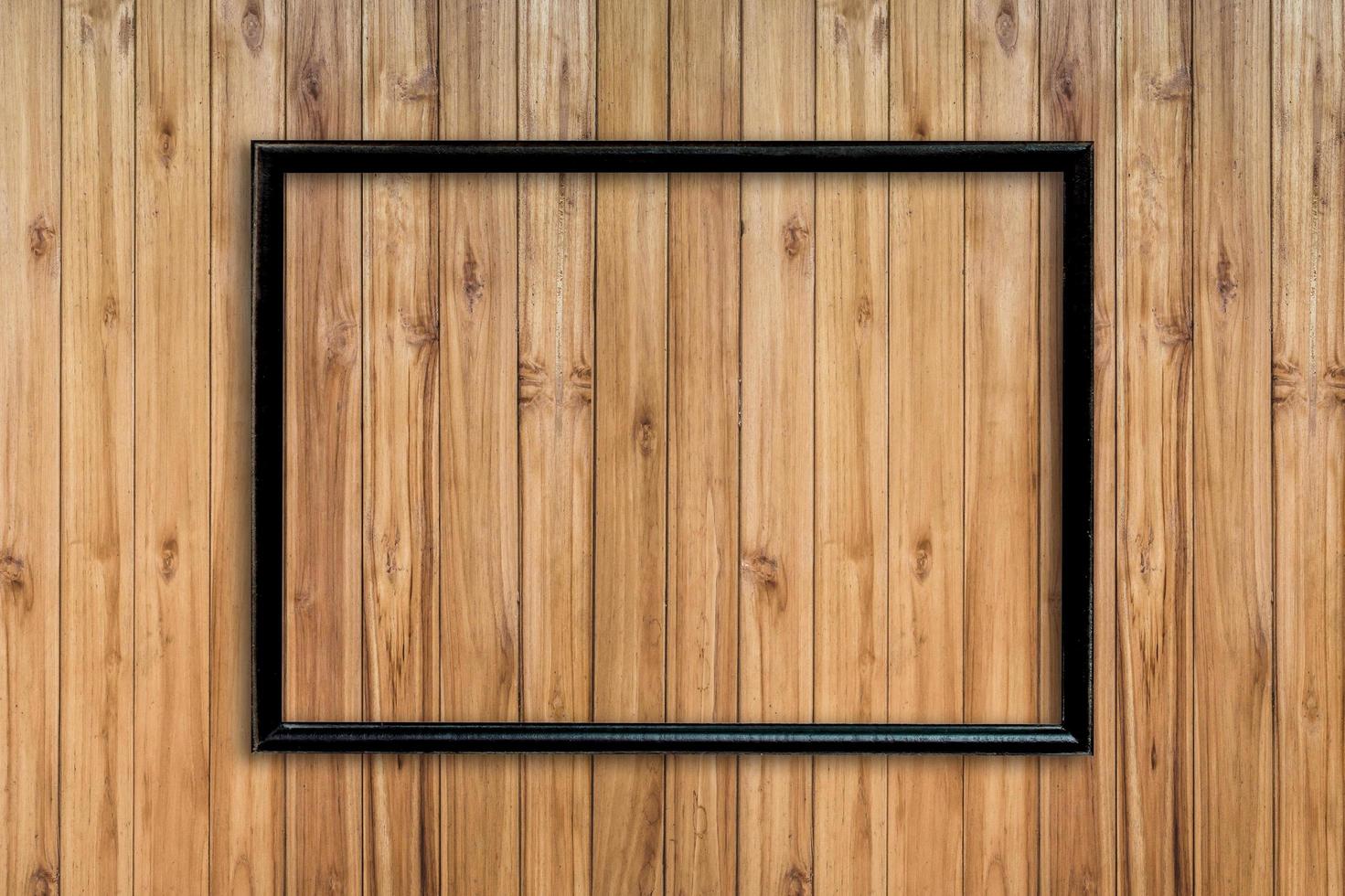 Old frame picture on wood background with space. photo