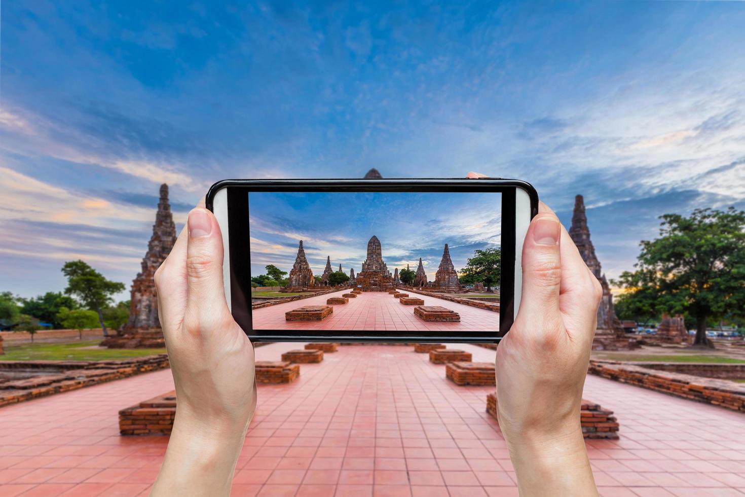 hand taking photo at wat chaiwatthanaram temple ayutthaya thailand ayutthaya historical park