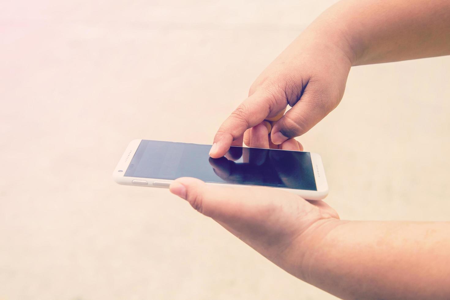 Hand holding smartphone and touchsceen display photo