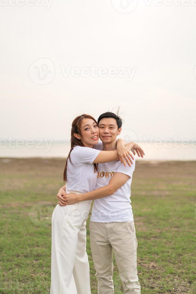 Happy young Asian couple in bride and groom t-shirt photo