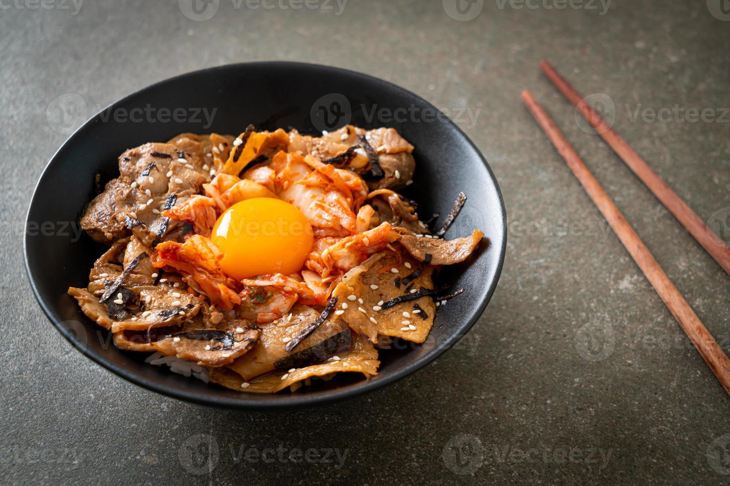 pork bulgogi rice bowl with kimchi and Korean pickled egg photo