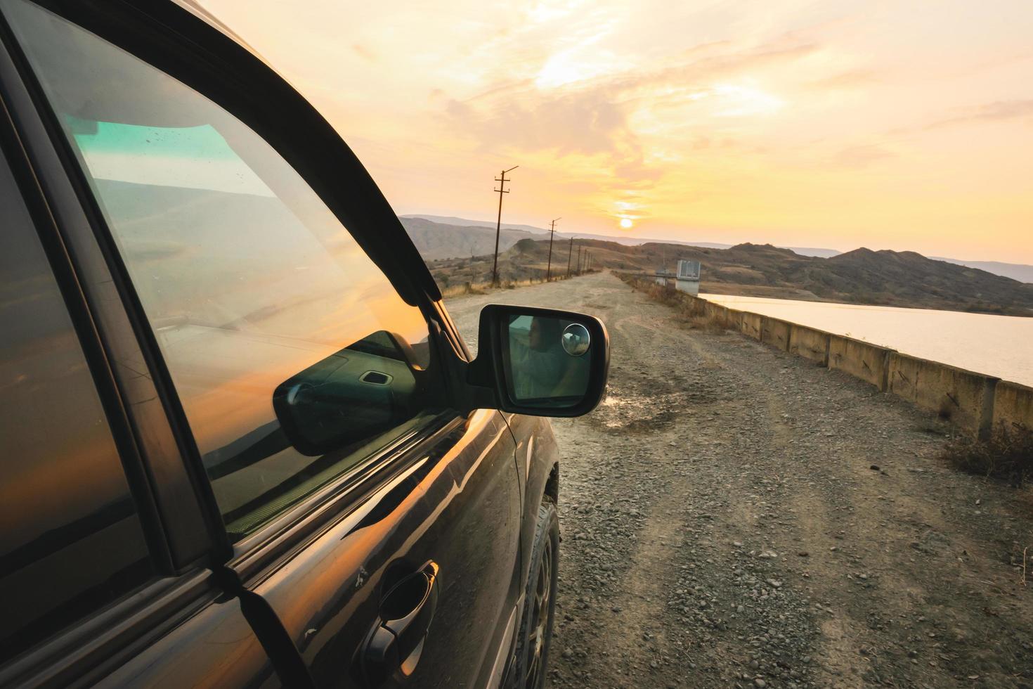 Close up car view on gravel road on the bridge with sunset in the background. Chachuna managed reserve road photo