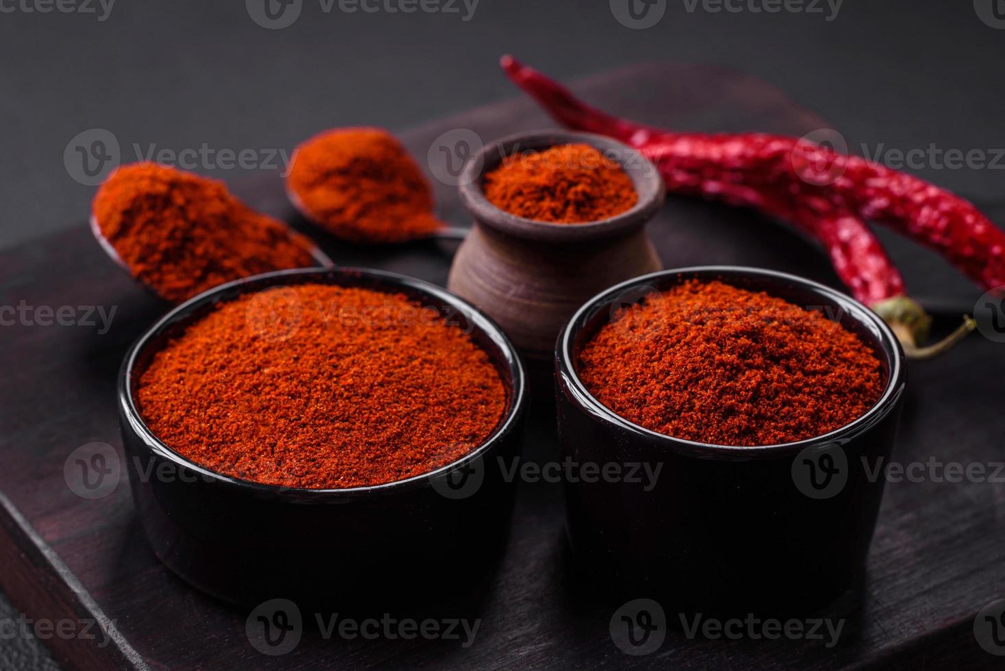 Spice smoked paprika in the form of powder in bowls and spoons photo