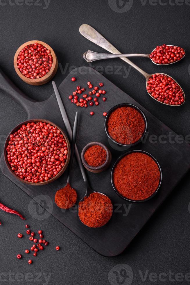 Spice smoked paprika in the form of powder in bowls and spoons photo