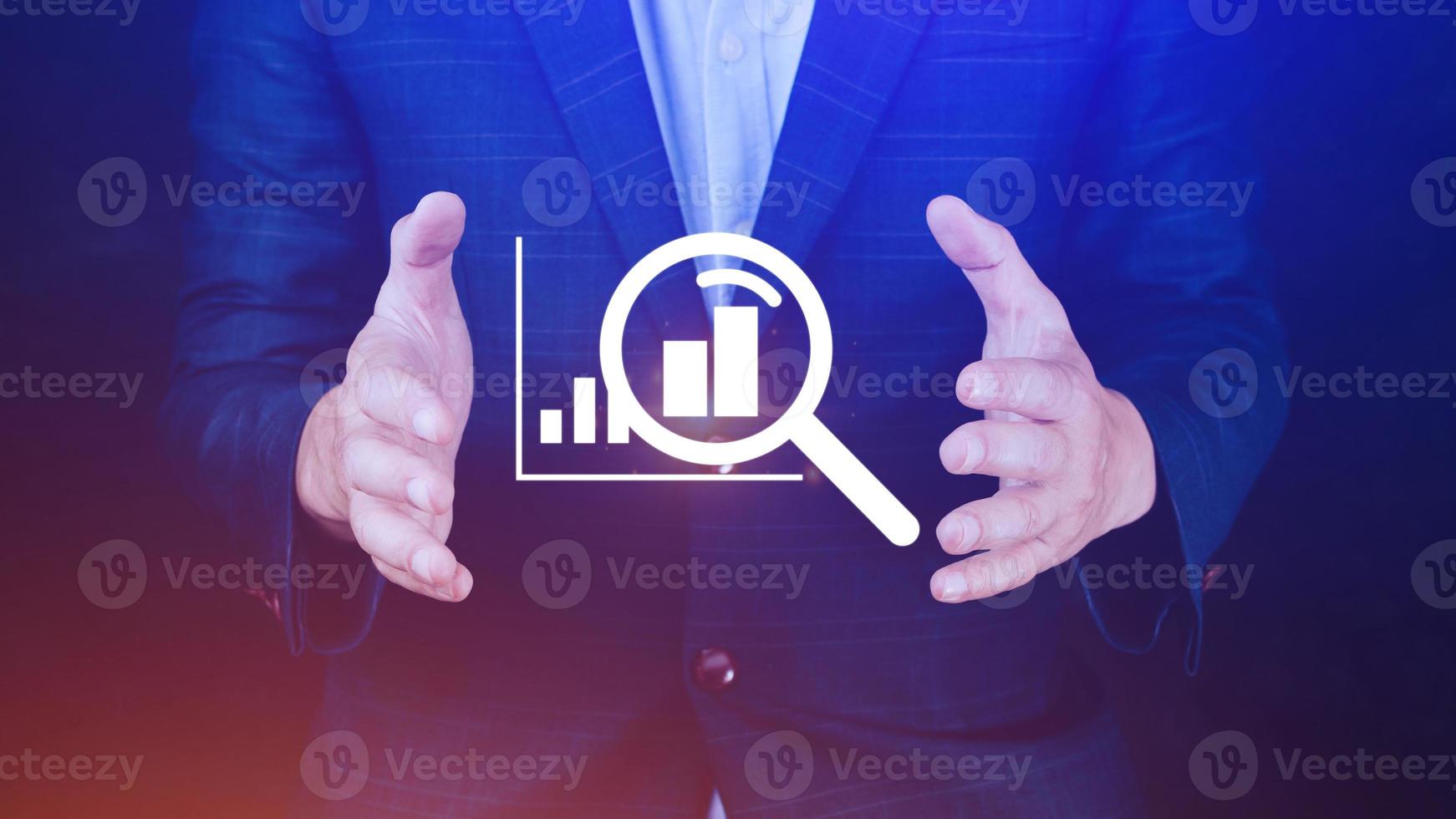 Businessman showing business growth on graph Hands touching graphs representing increasing profits with virtual interface technology, financial symbols coming photo