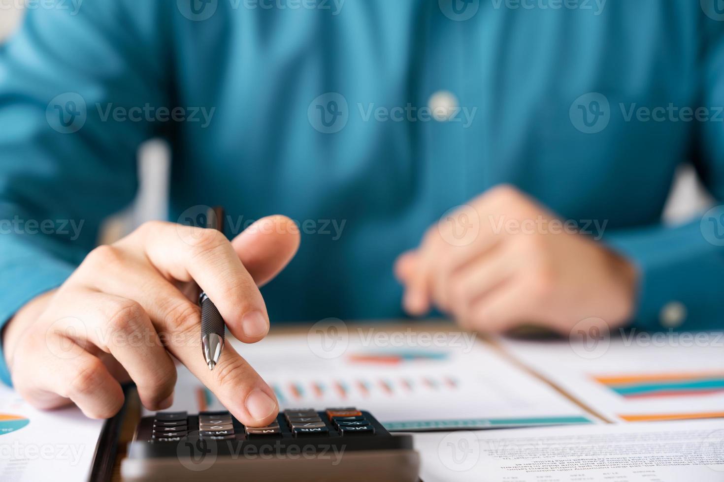 Investors are calculating profits and costs with calculators, growth and investment chart analysis, business planning and strategies to maximize sales profits. Long term business plan. photo