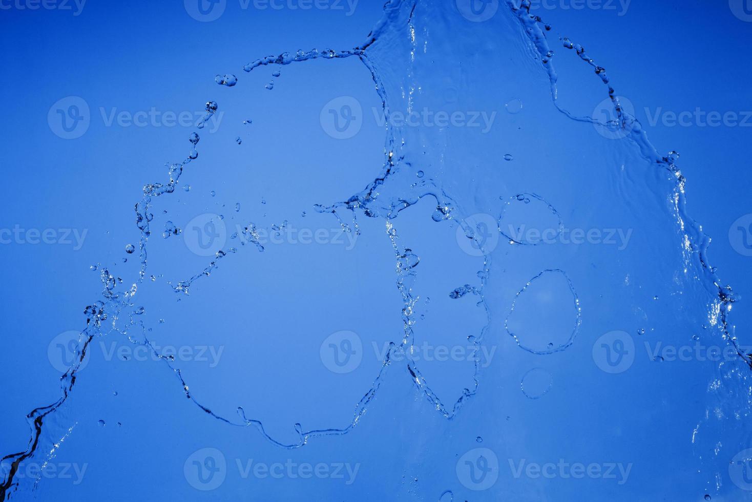 Falling water on a blue background photo