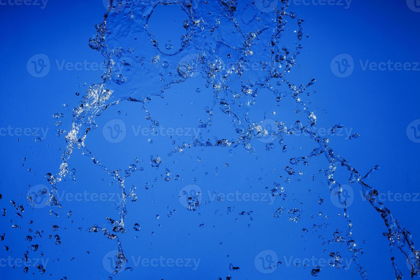 Falling water on a blue background photo