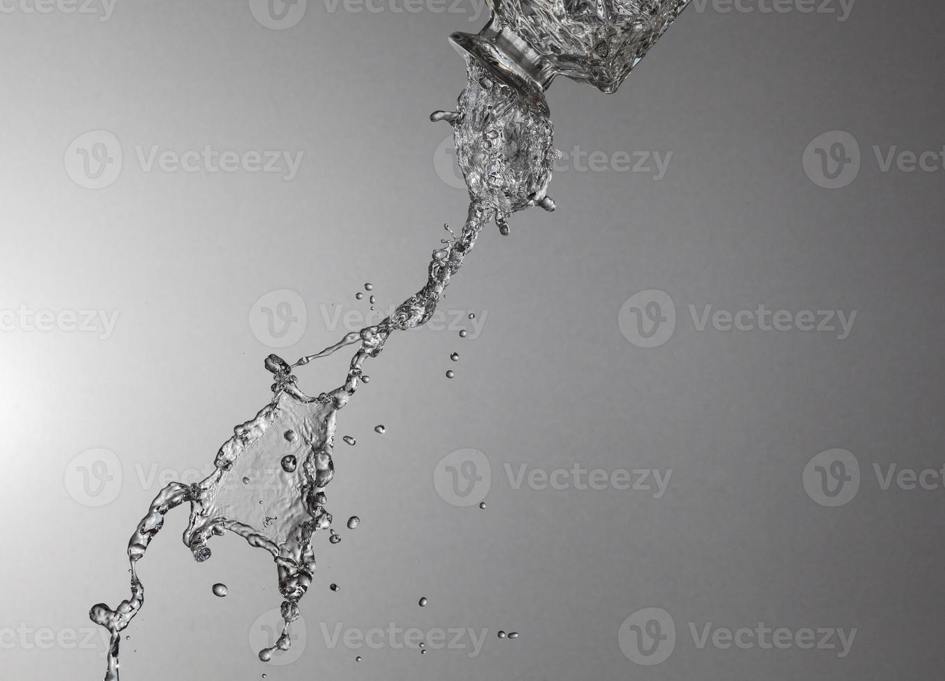 Falling water on a silver background photo