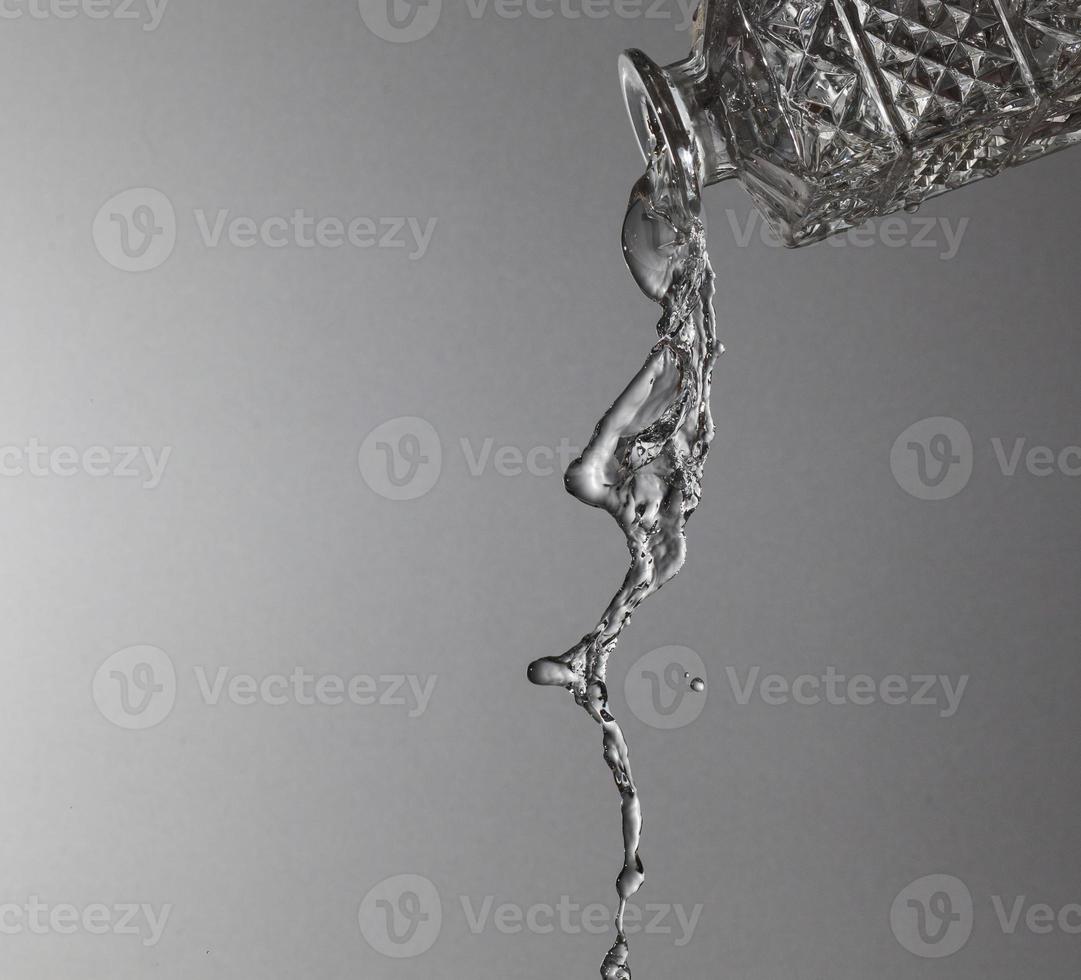 Falling water on a silver background photo