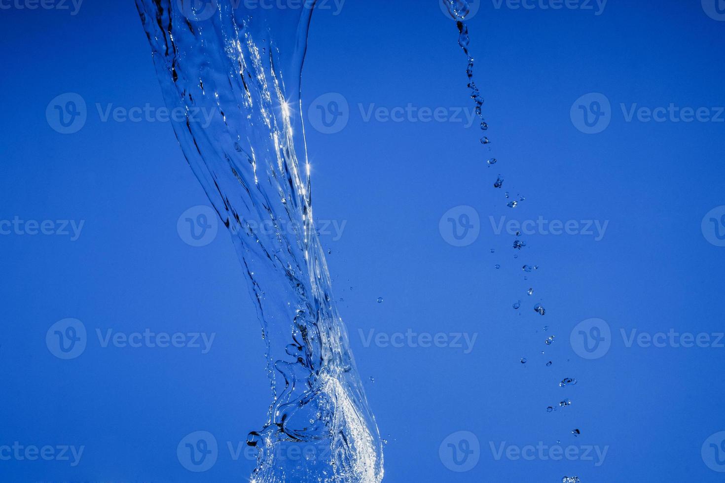 Falling water on a blue background photo