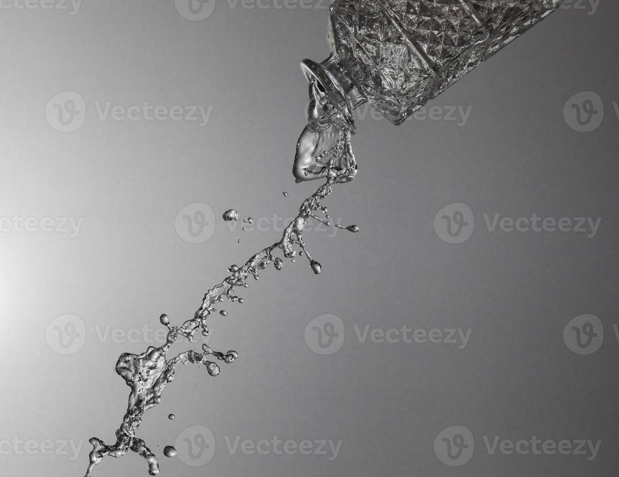 Falling water on a silver background photo