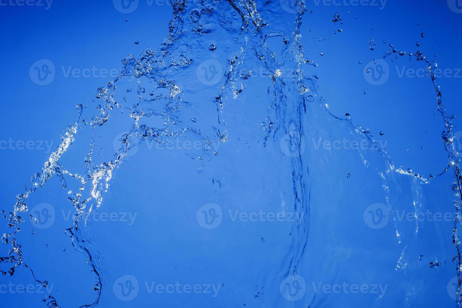 Falling water on a blue background photo