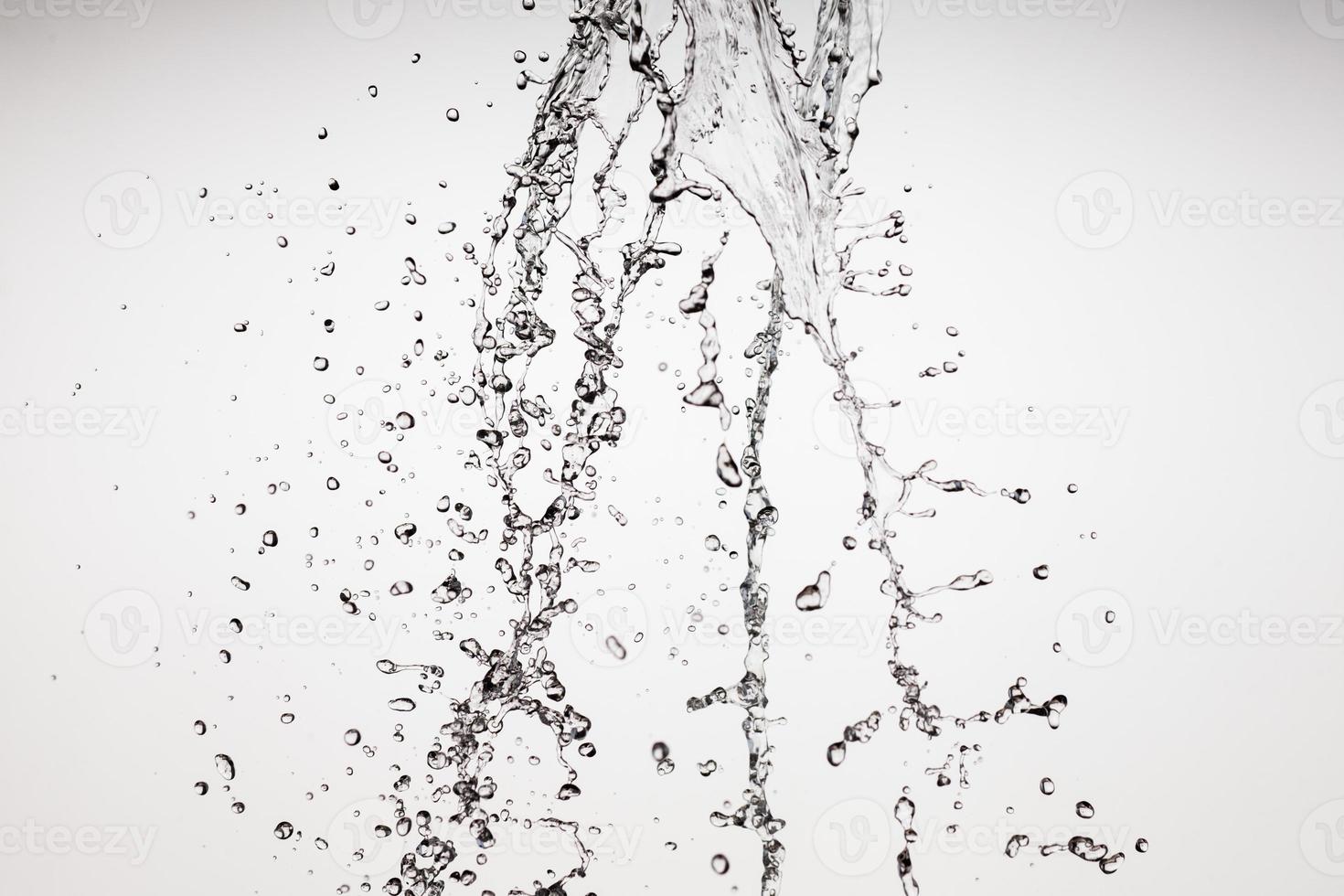 Falling water on a white background photo