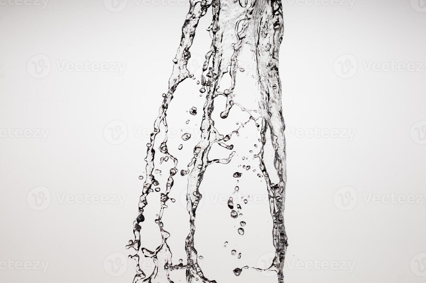 Falling water on a white background photo