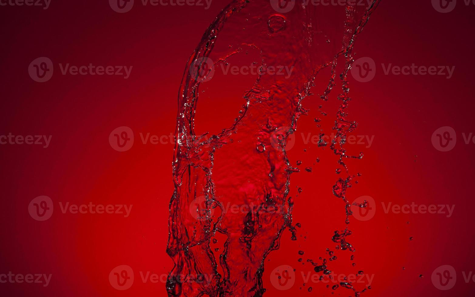 Falling water on a red background photo