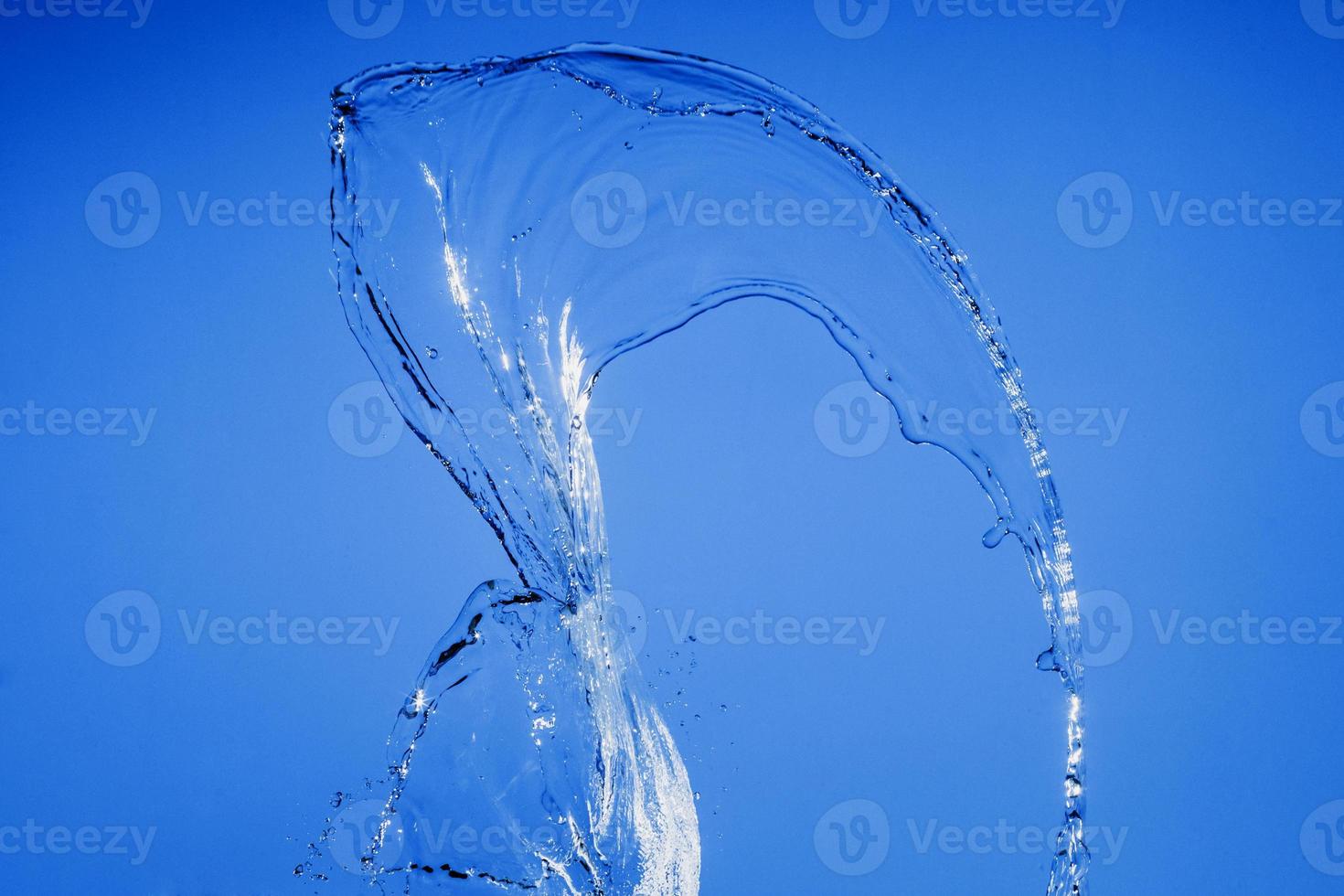 Falling water on a blue background photo