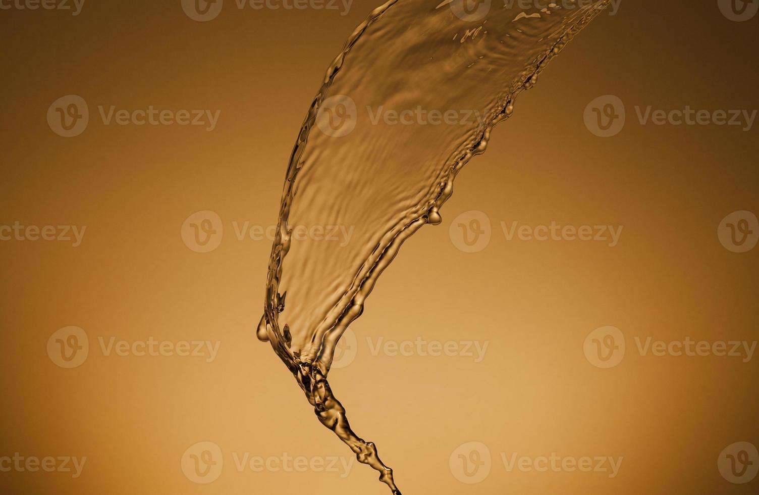 Falling water on a golden background photo