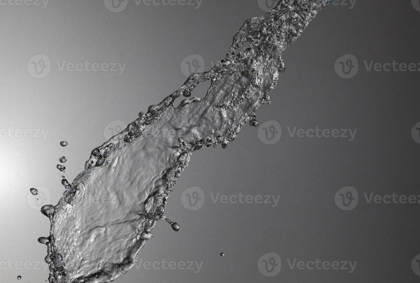 Falling water on a silver background photo