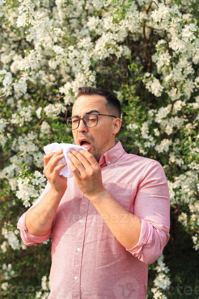 sneezing man during seasonal allergies photo