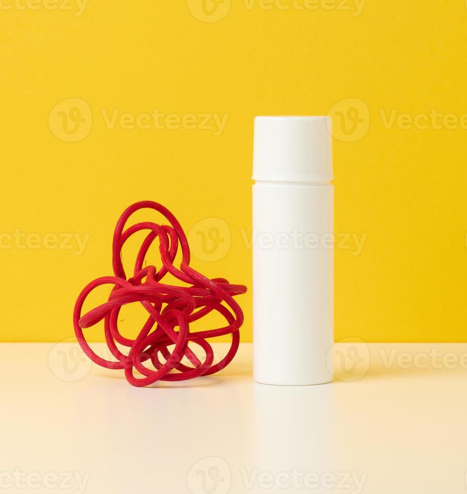 empty white plastic bottle on a yellow background. Cosmetic products for branding gel, cream, lotion, shampoo. Mock up photo