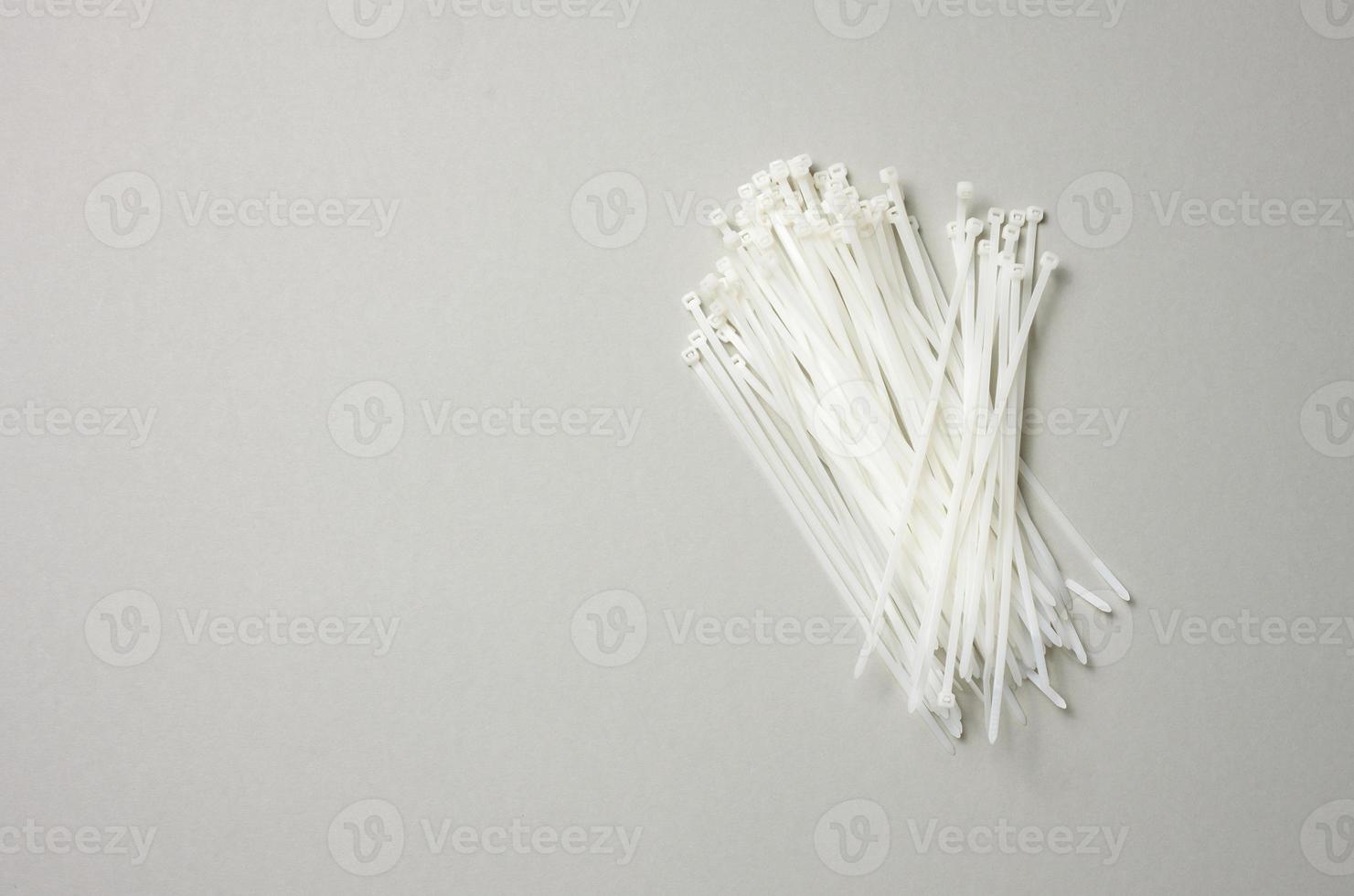 stack of plastic cable ties on gray background. View from above photo
