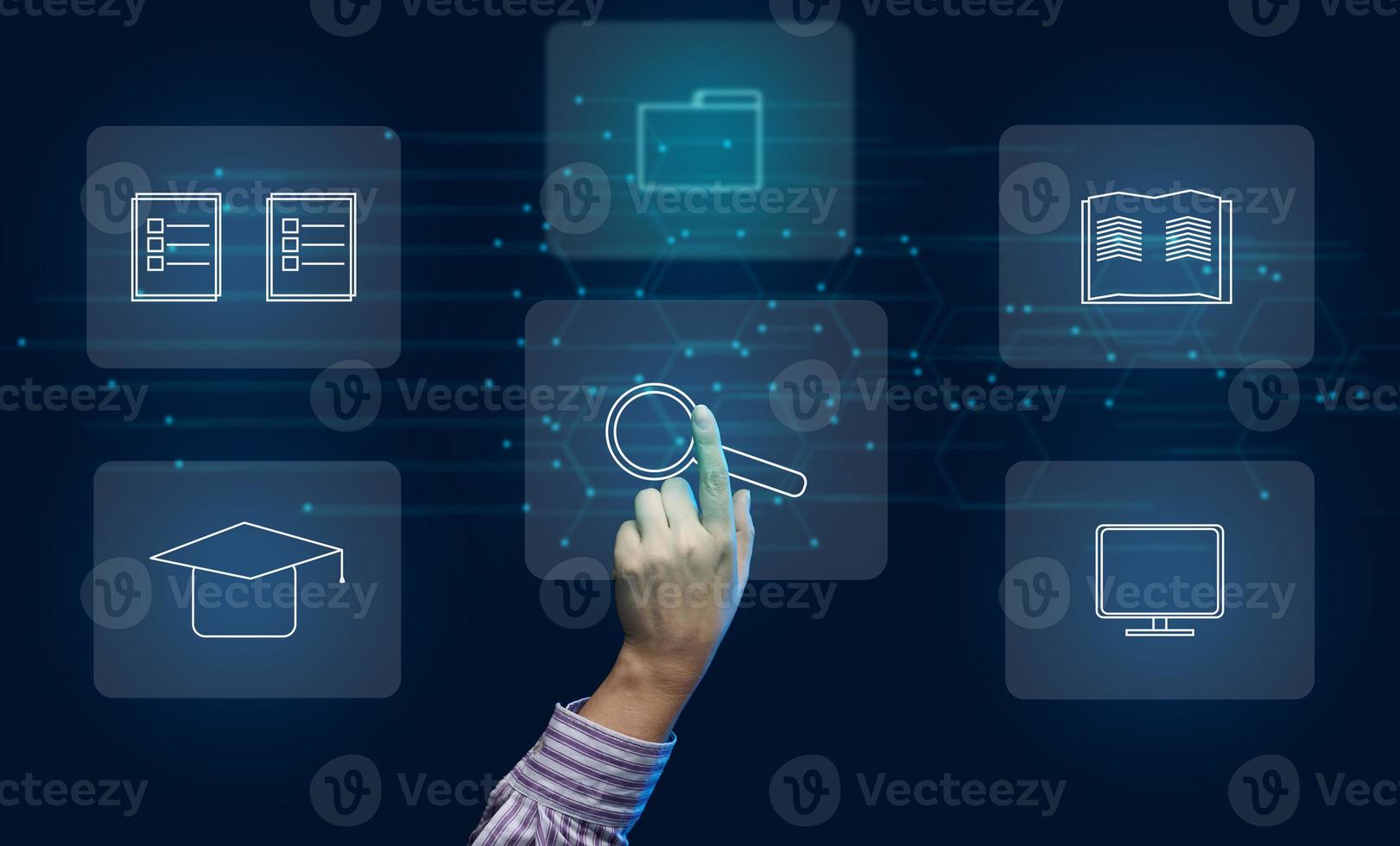 A hand selects icons on a virtual screen. The concept of distance learning, methods of searching for systematization and information retrieval photo