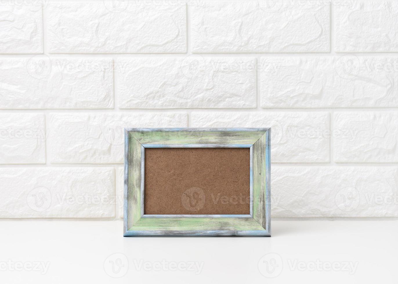 empty white wooden photo frame on white table, white background