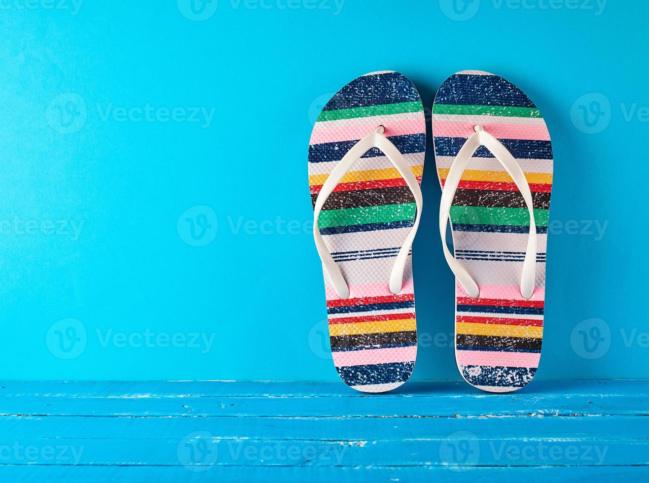 pair of female beach slippers on a blue background photo