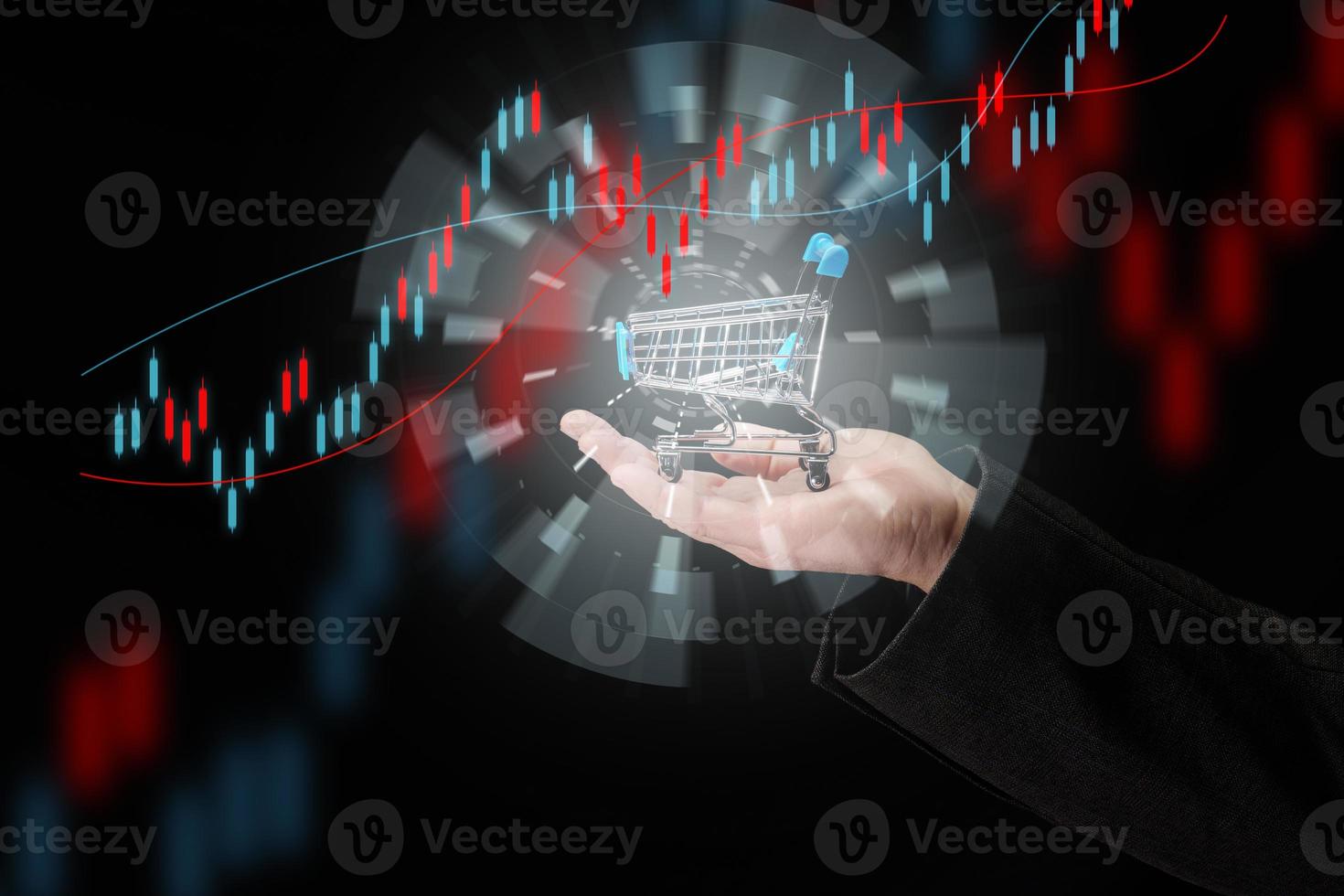 man's hand holds a miniature shopping cart on a dark blue background, the concept of the start of world sales, the growth of purchases. Online shopping photo