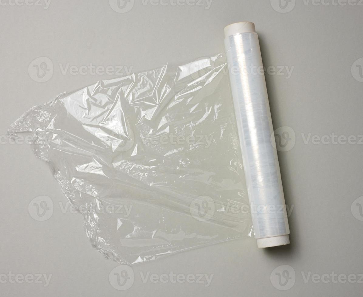 roll of transparent cling film for packaging ona gray background, top view photo