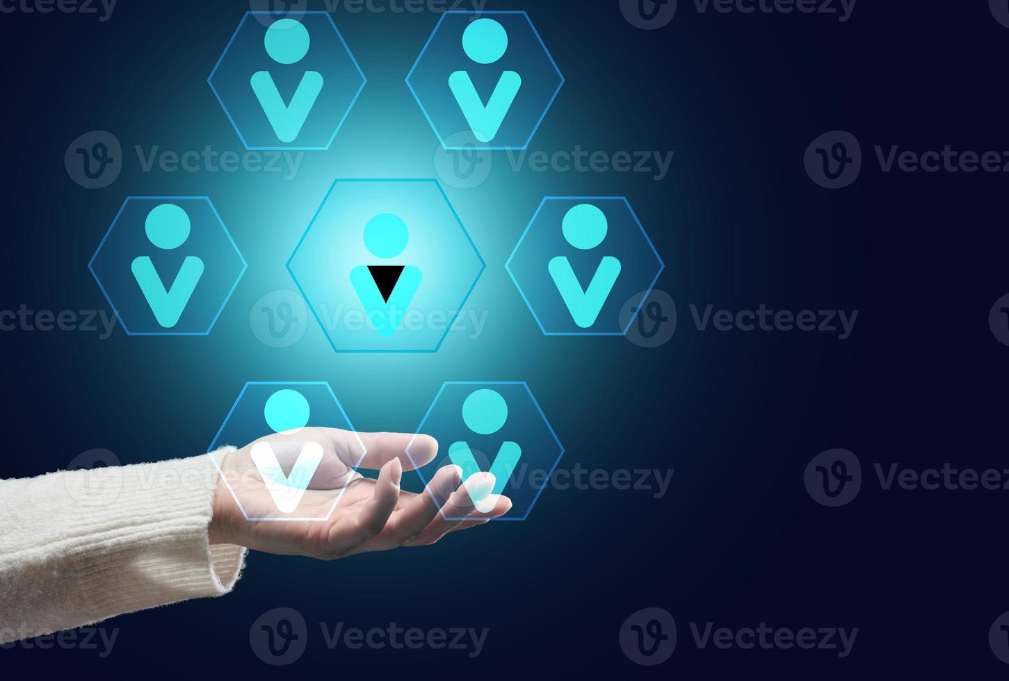 female hand on a dark background and the hierarchical structure of the team photo