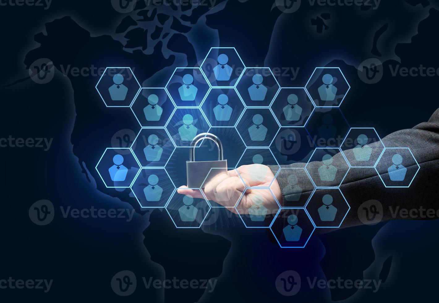 male hand holding a metal padlock on a dark blue background photo