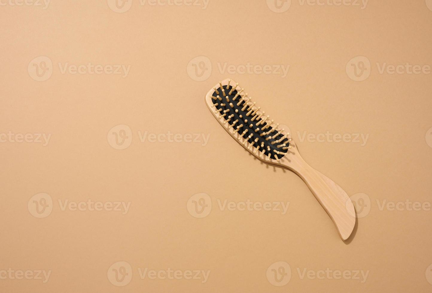 wooden hair comb on brown background, zero waste photo