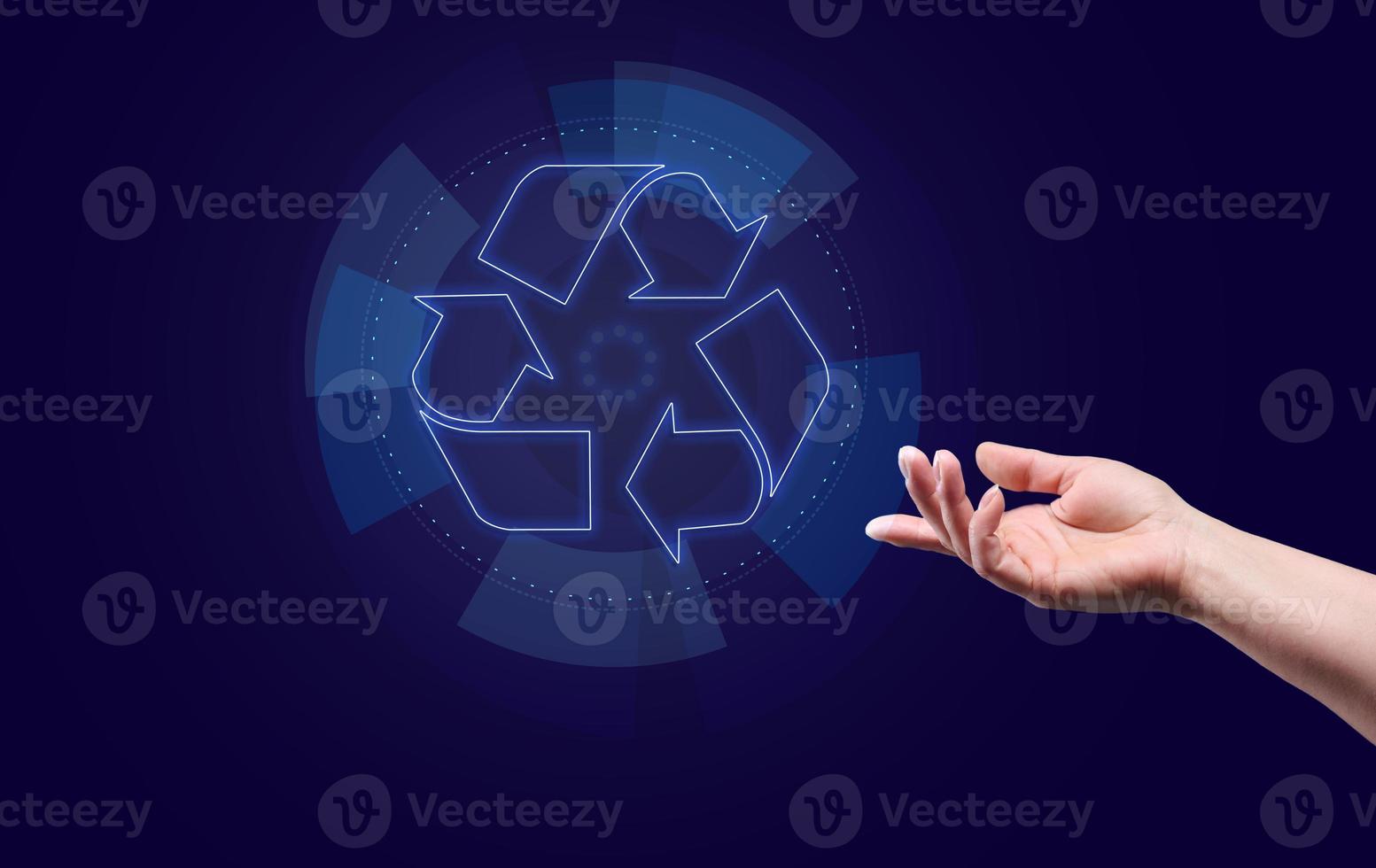 Blue glowing recycling sign floating above hand. photo
