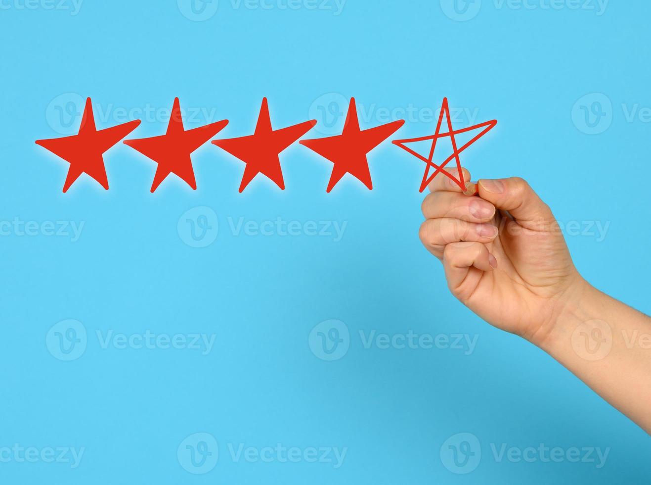 score five red stars and a female hand draws on a blue background, high rating photo