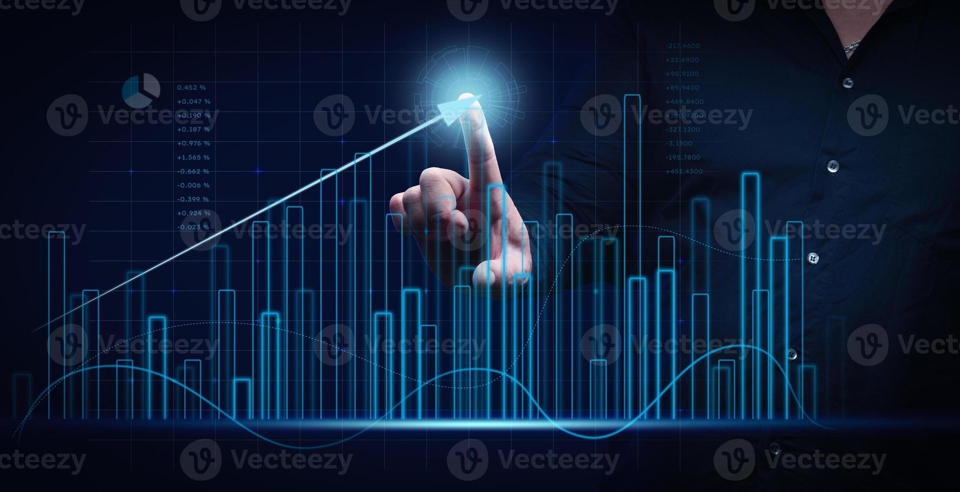 man in a black shirt stands in front of a holographic graph with growing indicators. Business growth, sales increase. High performance photo