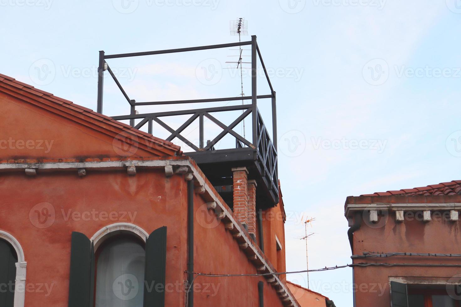Roof with balcony on the top, window of the old house photo. Venetian architecture. photo