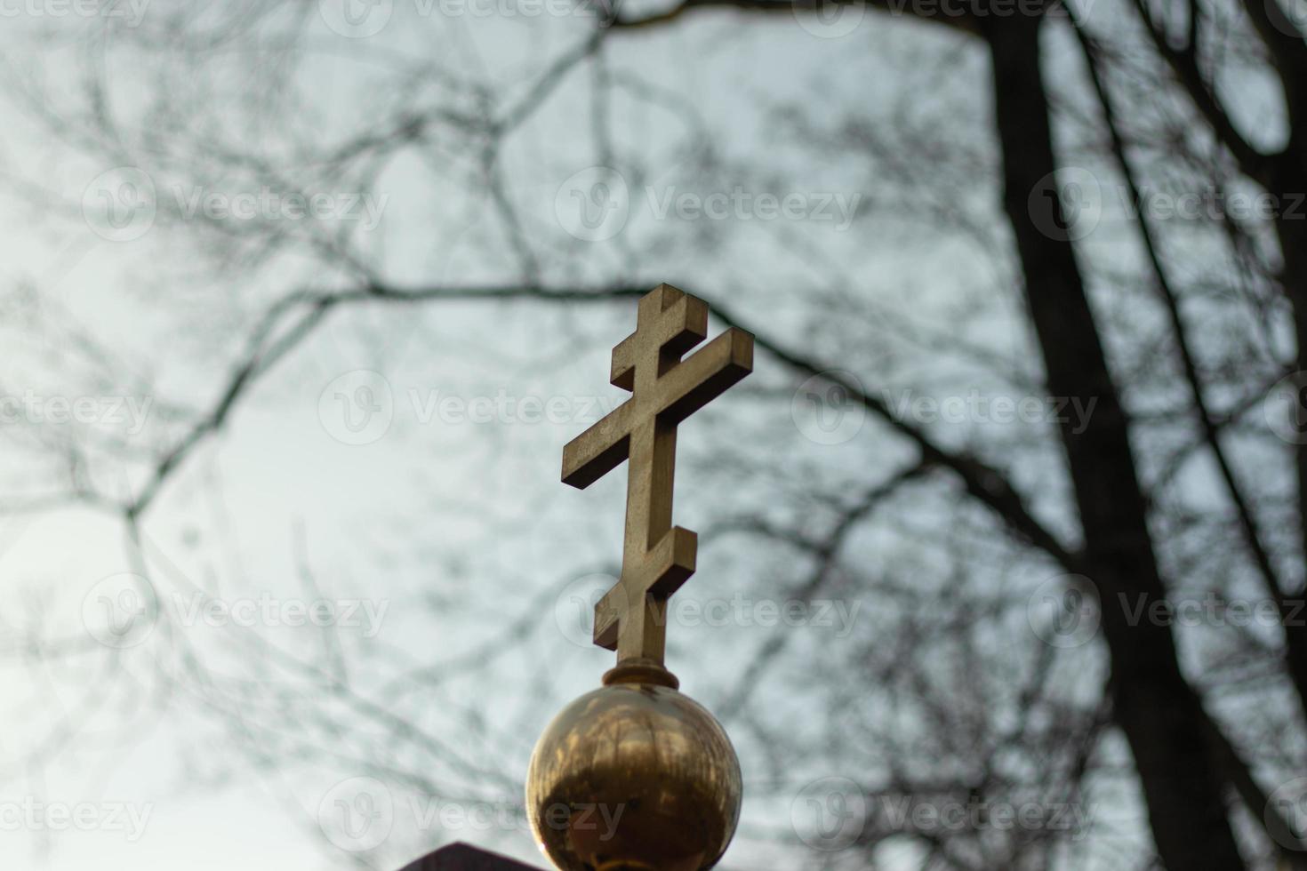 Orthodox cross on a gloomy sky background. Religion concept, faith problem photo