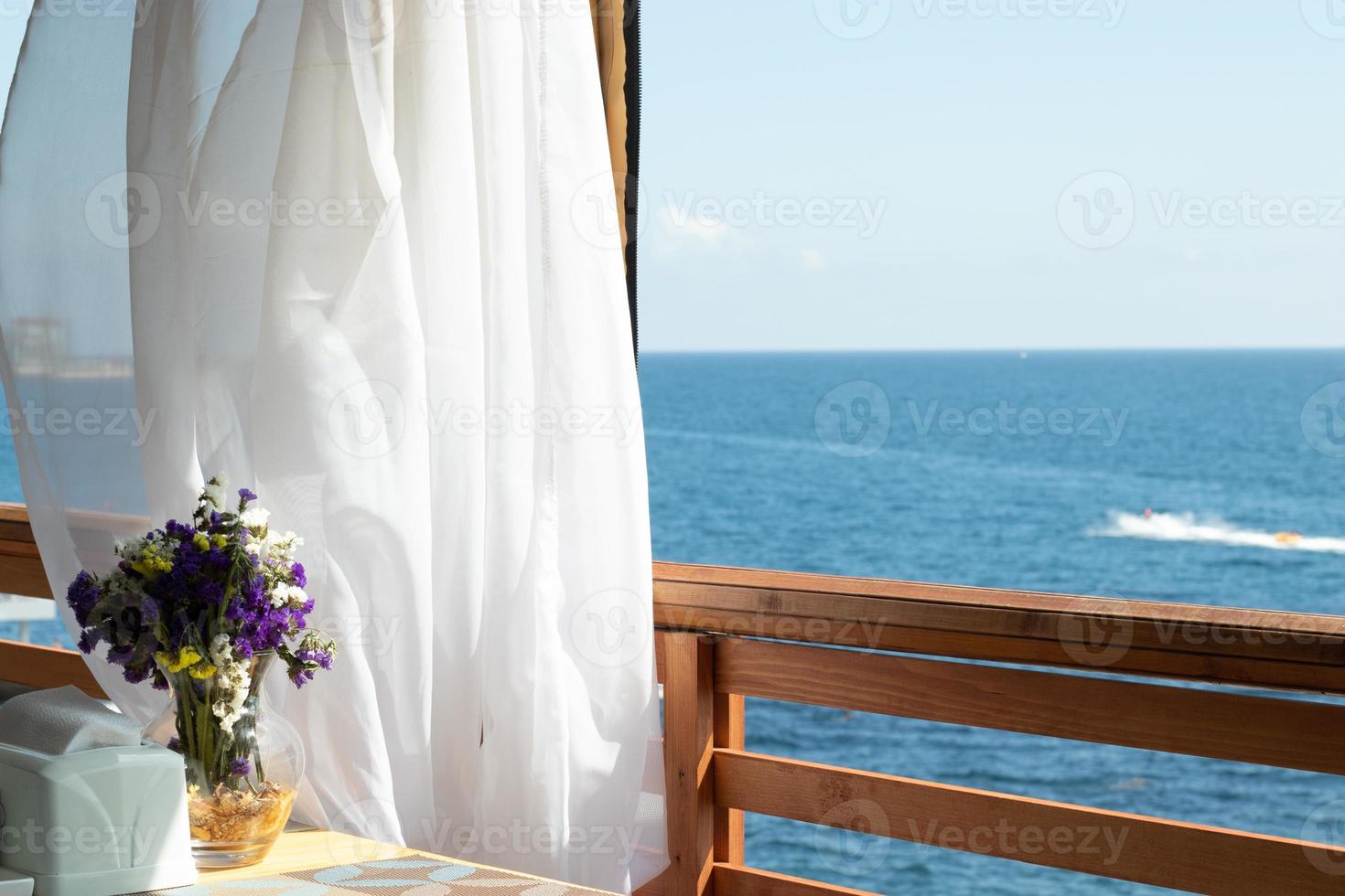 Sea view from an open summer cafe, copy space. Blue water and sky background photo