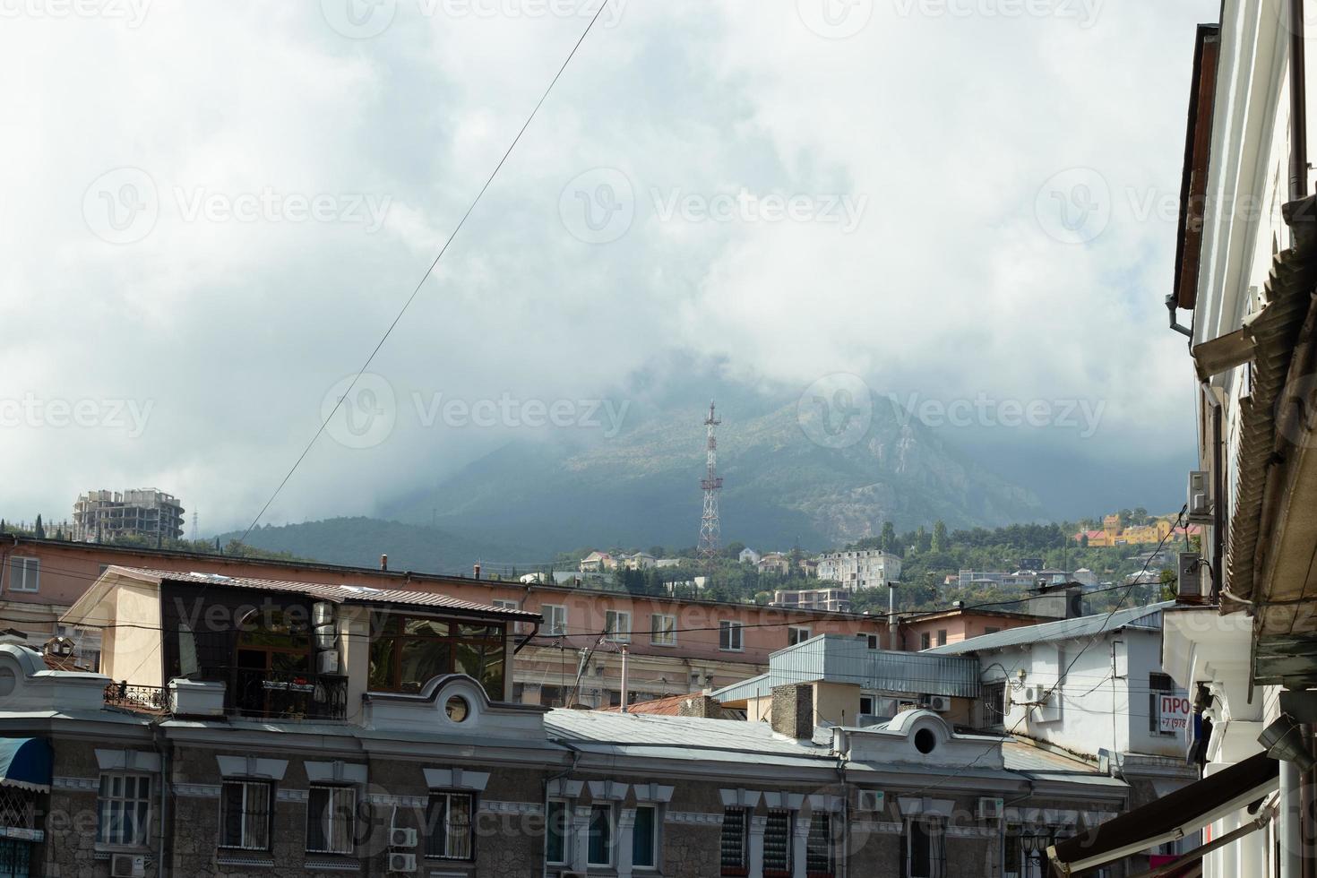 Fog in the mountains. A city in a wooded and mountainous area. Resort town for recreation photo